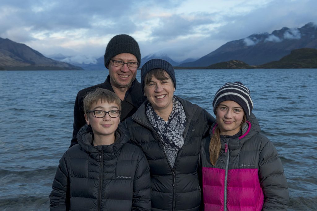 a family smiling near sea water